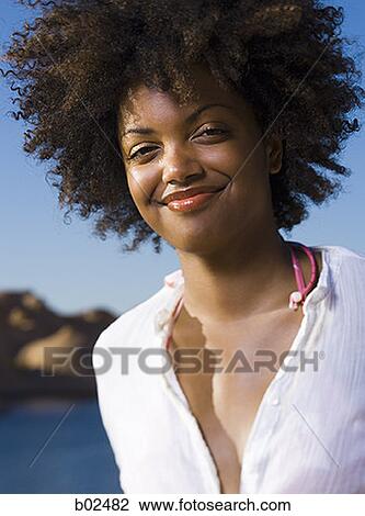 Portrait of a young woman grinning View Large Photo Image Stock Image - Portrait of a young woman grinning. Fotosearch