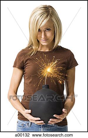 Stock Image - Portrait of a young woman holding a bomb. Fotosearch