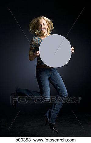 Portrait of a young woman holding a blank sign View Large Photo Image Stock Image - Portrait of a young woman holding a blank sign. Fotosearch
