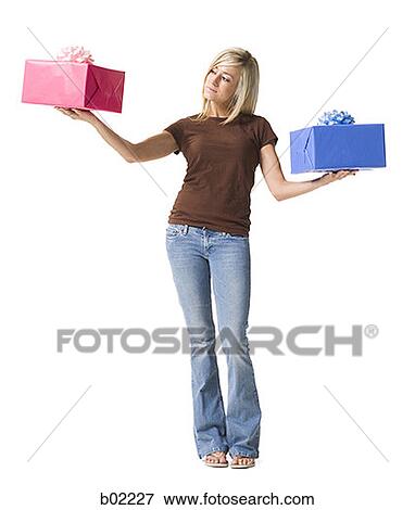 Portrait of a young woman holding gifts View Large Photo Image Stock Photo - Portrait of a young woman holding gifts. Fotosearch