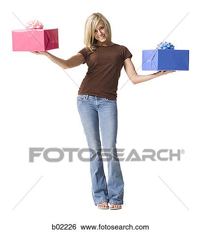 Portrait of a young woman holding gifts View Large Photo Image Stock Photograph - Portrait of a young woman holding gifts. Fotosearch