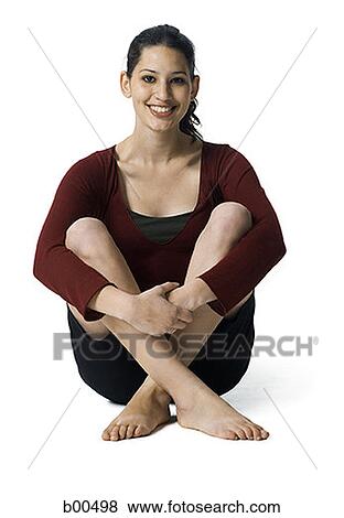 Portrait of a young woman holding her knees View Large Photo Image Stock Photo - Portrait of a young woman holding her knees. Fotosearch