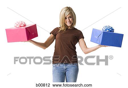Portrait of a young woman holding two gifts View Large Photo Image Stock Image - Portrait of a young woman holding two gifts. Fotosearch