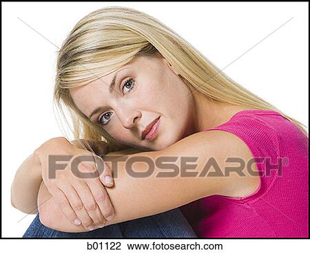 Portrait of a young woman hugging her knees View Large Photo Image Stock Image - Portrait of a young woman hugging her knees. Fotosearch