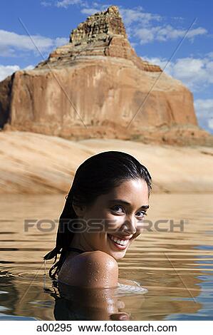 Stock Photography - Portrait of a young woman in a lake. Fotosearch