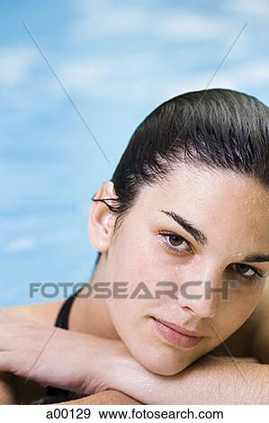 Portrait of a young woman in a swimming pool View Large Photo Image Stock Photo - Portrait of a young woman in a swimming pool. Fotosearch