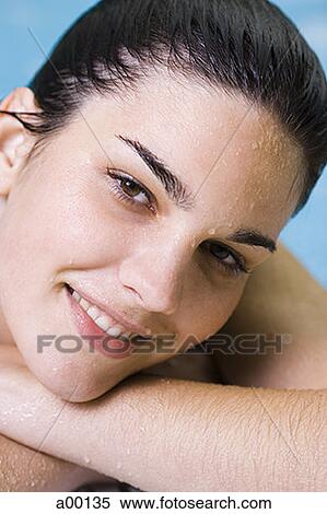 Portrait of a young woman in a swimming pool View Large Photo Image Stock Photography - Portrait of a young woman in a swimming pool. Fotosearch