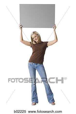 Portrait of a young woman lifting up a blank sign View Large Photo Image Stock Photography - Portrait of a young woman lifting up a blank sign. Fotosearch