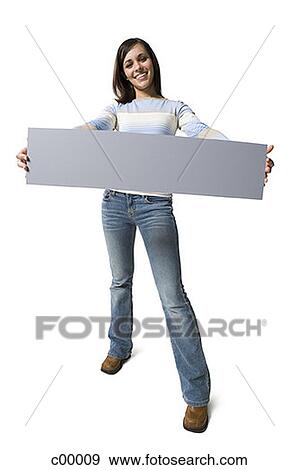 Portrait of a young woman showing a blank sign View Large Photo Image Stock Photo - Portrait of a young woman showing a blank sign. Fotosearch