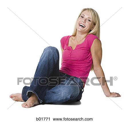 Portrait of a young woman sitting on the floor View Large Photo Image Stock Image - Portrait of a young woman sitting on the floor. Fotosearch