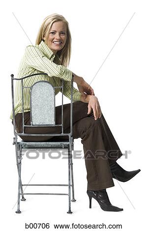 Portrait of a young woman sitting on the floor with her legs crossed View Large Photo Image Stock Photograph - Portrait of a young woman sitting on the floor with her legs crossed. Fotosearch