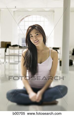 Portrait of a young woman sitting on the floor View Large Photo Image Stock Photography - Portrait of a young woman sitting on the floor. Fotosearch