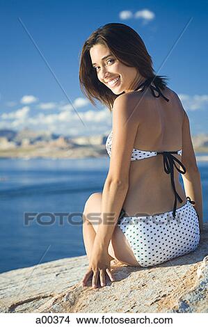 Portrait of a young woman sitting, lakeside View Large Photo Image Picture - Portrait of a young woman sitting, lakeside. Fotosearch