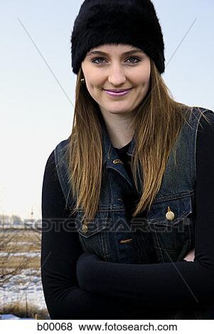 Portrait of a young woman smiling in winter View Large Photo Image Stock Photo - Portrait of a young woman smiling in winter. Fotosearch