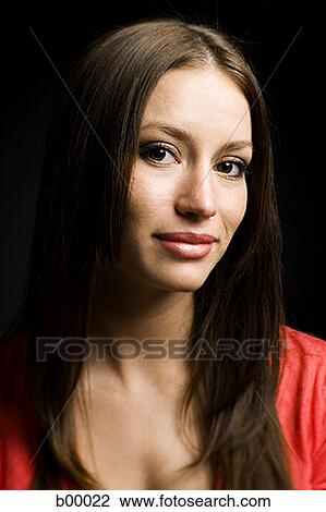Stock Image - Portrait of a young woman smiling. Fotosearch