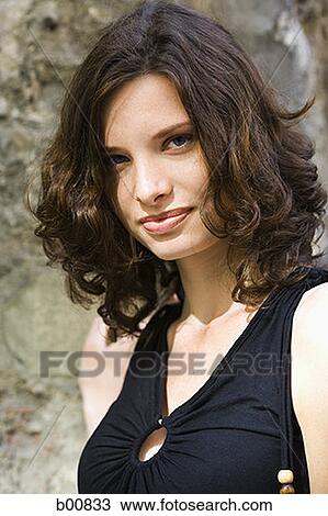 Portrait of a young woman smiling View Large Photo Image Stock Image - Portrait of a young woman smiling. Fotosearch