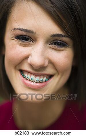 Portrait of a young woman smiling View Large Photo Image Stock Image - Portrait of a young woman smiling. Fotosearch