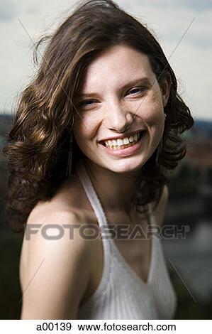 Portrait of a young woman smiling View Large Photo Image Stock Photo - Portrait of a young woman smiling. Fotosearch