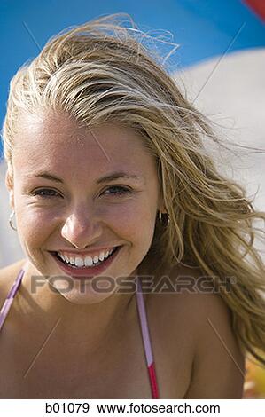 Portrait of a young woman smiling View Large Photo Image Stock Photo - Portrait of a young woman smiling. Fotosearch
