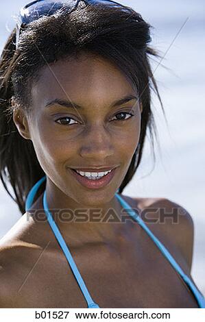 Portrait of a young woman smiling View Large Photo Image Stock Photo - Portrait of a young woman smiling. Fotosearch