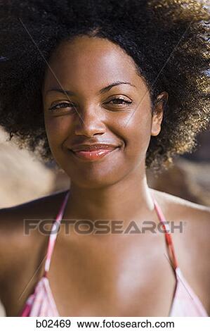 Portrait of a young woman smiling View Large Photo Image Stock Photo - Portrait of a young woman smiling. Fotosearch