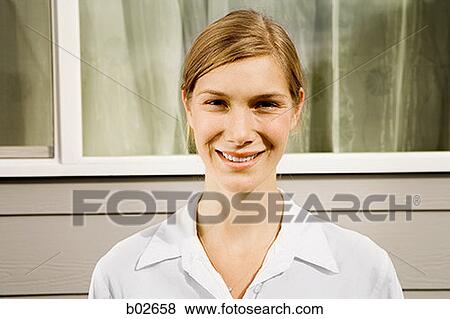 Portrait of a young woman smiling View Large Photo Image Stock Photo - Portrait of a young woman smiling. Fotosearch