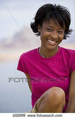 Portrait of a young woman smiling View Large Photo Image Stock Photo - Portrait of a young woman smiling. Fotosearch