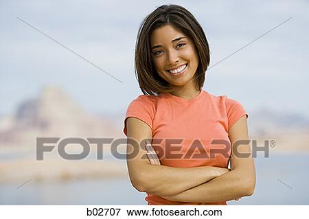 Portrait of a young woman smiling View Large Photo Image Stock Photo - Portrait of a young woman smiling. Fotosearch