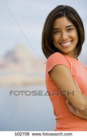 Portrait of a young woman smiling View Large Photo Image Stock Photo - Portrait of a young woman smiling. Fotosearch
