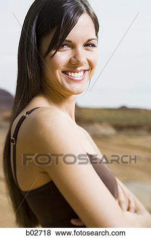 Portrait of a young woman smiling View Large Photo Image Stock Photo - Portrait of a young woman smiling. Fotosearch
