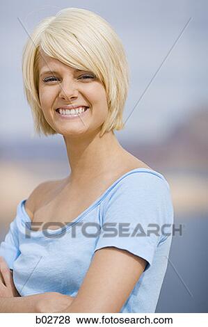 Portrait of a young woman smiling View Large Photo Image Stock Photo - Portrait of a young woman smiling. Fotosearch