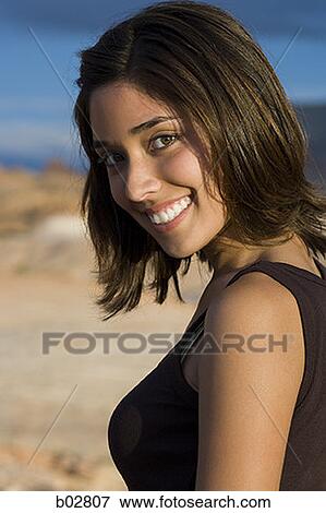 Stock Photo - Portrait of a young woman smiling. Fotosearch