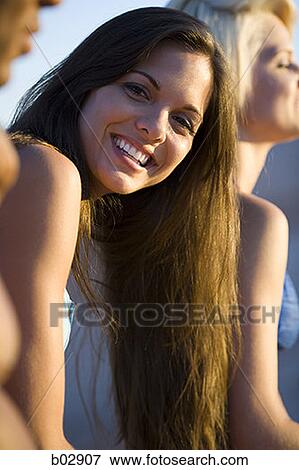 Portrait of a young woman smiling View Large Photo Image Stock Photo - Portrait of a young woman smiling. Fotosearch
