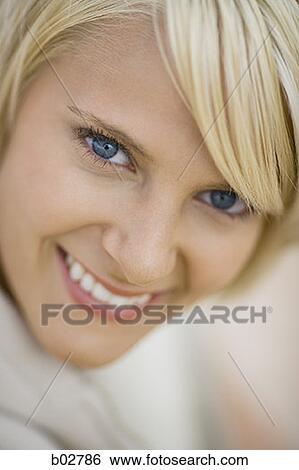 Portrait of a young woman smiling View Large Photo Image Stock Photograph - Portrait of a young woman smiling. Fotosearch