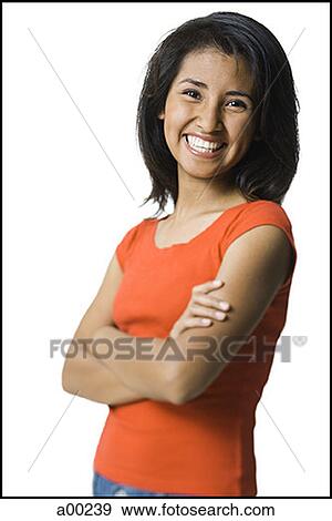 Portrait of a young woman smiling with her arms crossed View Large Photo Image Stock Photo - Portrait of a young woman smiling with her arms crossed. Fotosearch