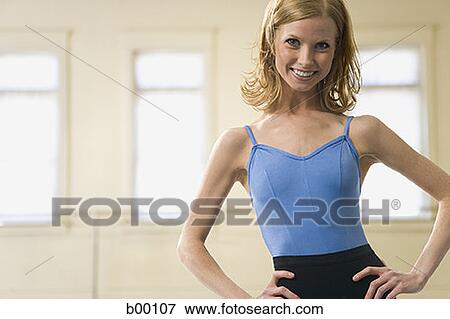 Portrait of a young woman smiling with arms akimbo View Large Photo Image Stock Photo - Portrait of a young woman smiling with arms akimbo. Fotosearch