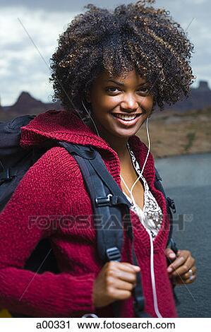 Portrait of a young woman standing on a lakeside View Large Photo Image Stock Image - Portrait of a young woman standing on a lakeside. Fotosearch
