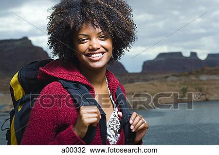 Portrait of a young woman standing on a lakeside View Large Photo Image Stock Image - Portrait of a young woman standing on a lakeside. Fotosearch