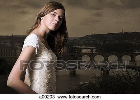 Stock Image - Portrait of a young woman standing. Fotosearch