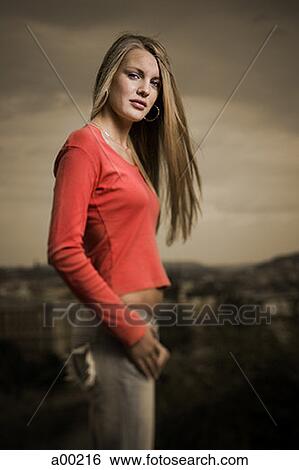 Stock Photograph - Portrait of a young woman standing. Fotosearch