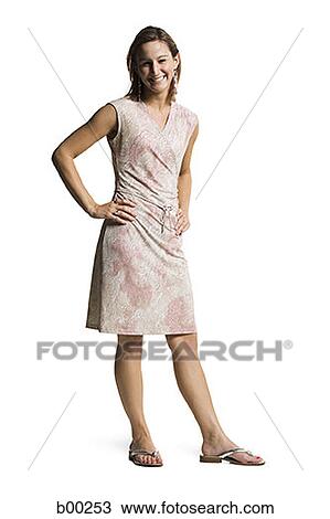 Portrait of a young woman standing with hands on hips View Large Photo Image Stock Image - Portrait of a young woman standing with hands on hips. Fotosearch
