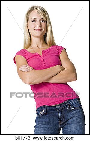 Stock Image - Portrait of a young woman standing with her arms folded. Fotosearch