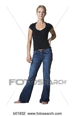 Portrait of a young woman standing with her hand on her hip View Large Photo Image Stock Image - Portrait of a young woman standing with her hand on her hip. Fotosearch