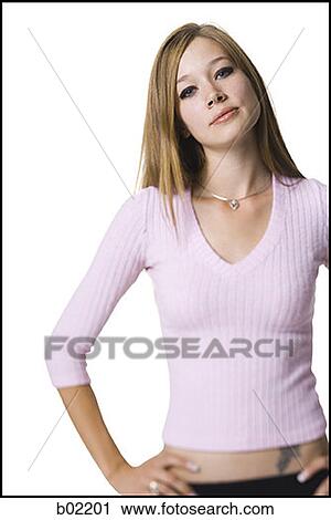Portrait of a young woman standing with hands on hips View Large Photo Image Stock Image - Portrait of a young woman standing with hands on hips. Fotosearch