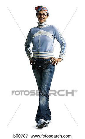 Portrait of a young woman standing with arms akimbo View Large Photo Image Stock Photo - Portrait of a young woman standing with arms akimbo. Fotosearch