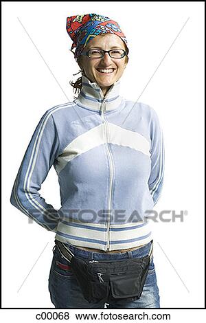 Stock Photo - Portrait of a young woman standing with her hands behind her back. Fotosearch