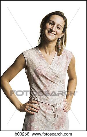 Portrait of a young woman standing with her hand on her hips View Large Photo Image Stock Photograph - Portrait of a young woman standing with her hand on her hips. Fotosearch
