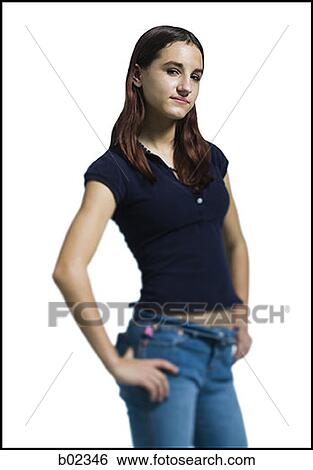 Portrait of a young woman standing with his hands on his hips View Large Photo Image Stock Photograph - Portrait of a young woman standing with his hands on his hips. Fotosearch