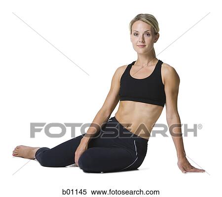 Portrait of a young woman standing with her hands on hips View Large Photo Image Stock Photography - Portrait of a young woman standing with her hands on hips. Fotosearch