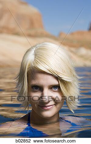 Portrait of a young woman swimming in a lake View Large Photo Image Stock Image - Portrait of a young woman swimming in a lake. Fotosearch